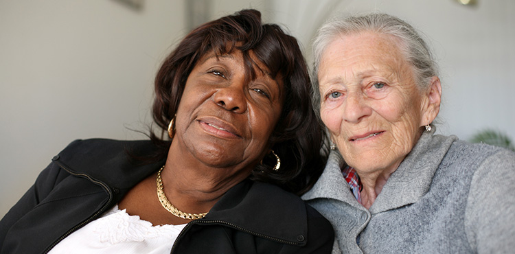 2 women sitting on a couch together