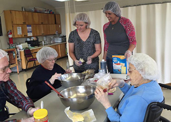 resident and nurses cooking together