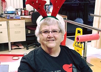 patient smiling with reindeer antlers on